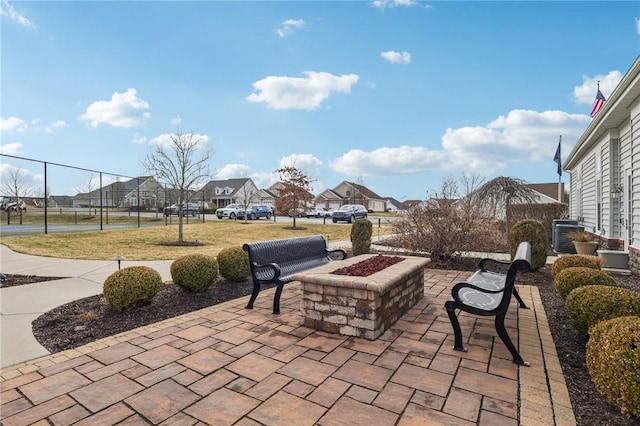 view of patio with a residential view, an outdoor fire pit, and fence