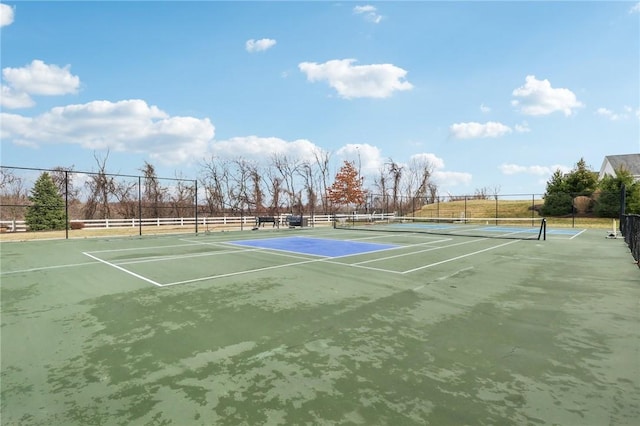 view of tennis court with fence