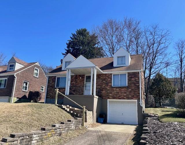 view of front facade featuring a porch, an attached garage, brick siding, stairs, and concrete driveway