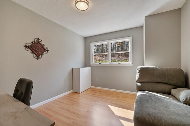 interior space with light wood-type flooring and baseboards