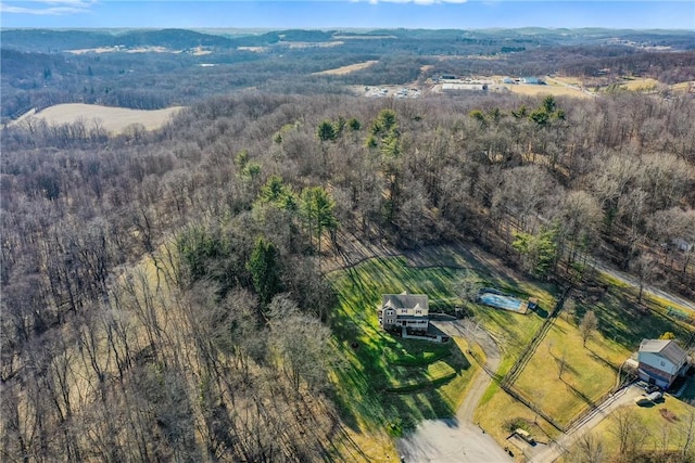 drone / aerial view featuring a rural view and a wooded view