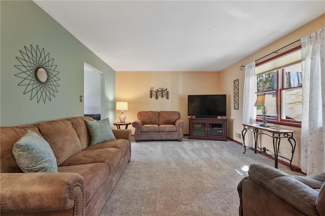 carpeted living area featuring baseboards