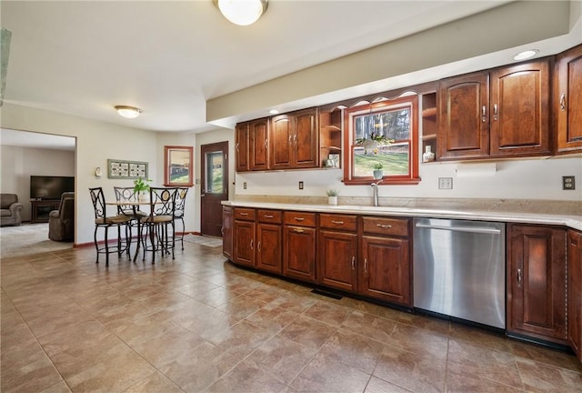 kitchen with a sink, open shelves, dishwasher, and light countertops