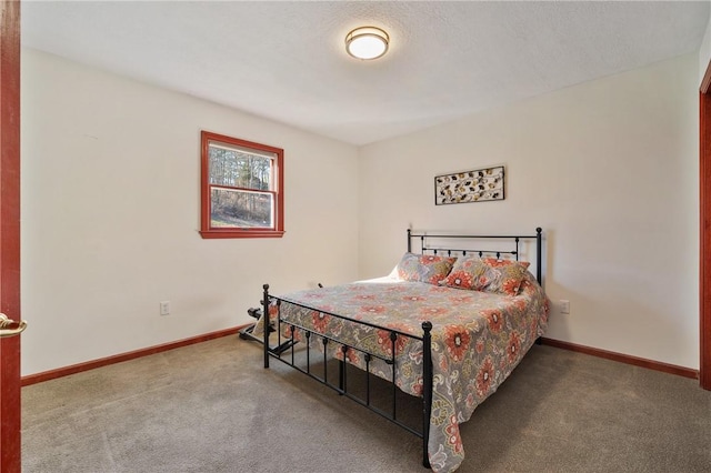 bedroom featuring carpet and baseboards