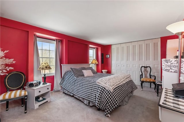 carpeted bedroom featuring a closet and multiple windows