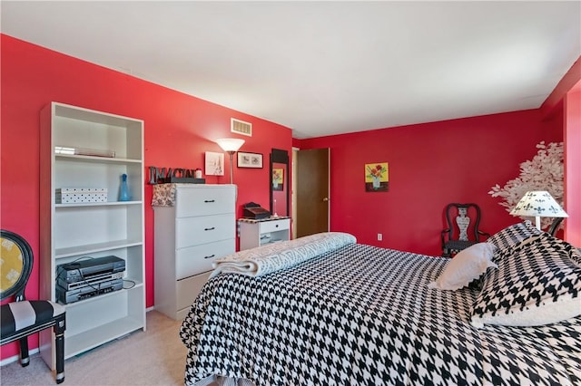 bedroom with visible vents and carpet flooring
