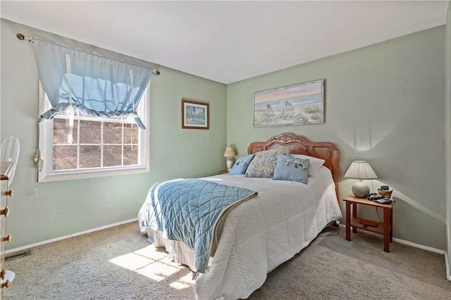 carpeted bedroom with visible vents and baseboards