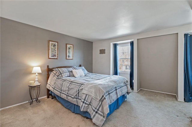 carpeted bedroom featuring baseboards