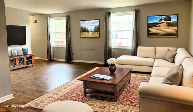 living room featuring wood finished floors, baseboards, and plenty of natural light