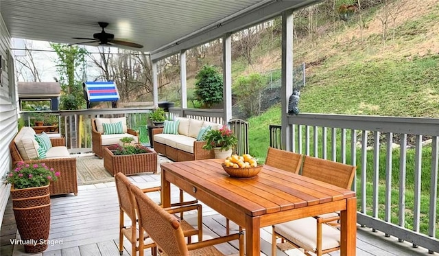 sunroom / solarium featuring an outdoor living space, outdoor dining space, and ceiling fan