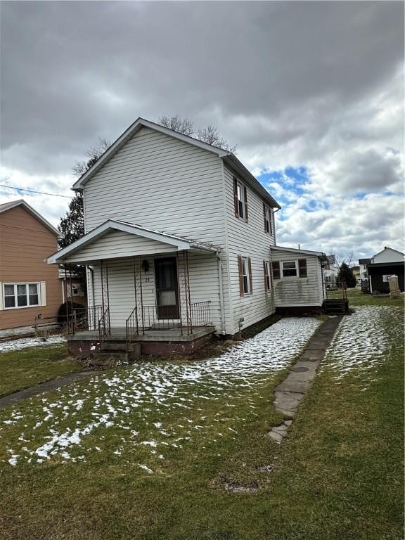 rear view of property featuring covered porch