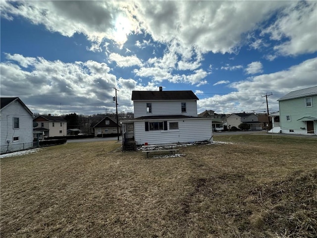 back of house featuring a yard