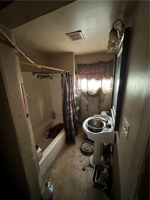 full bath with shower / bath combination with curtain, visible vents, and unfinished concrete flooring