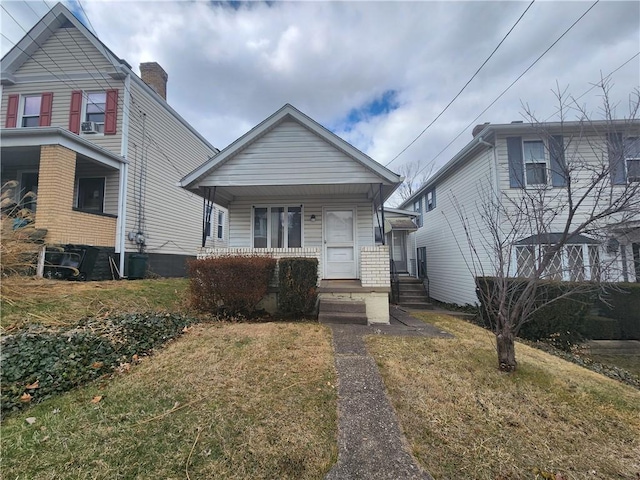 view of front facade with covered porch and a front yard