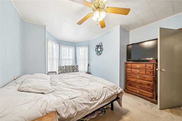 bedroom with a textured wall, ceiling fan, carpet flooring, and crown molding