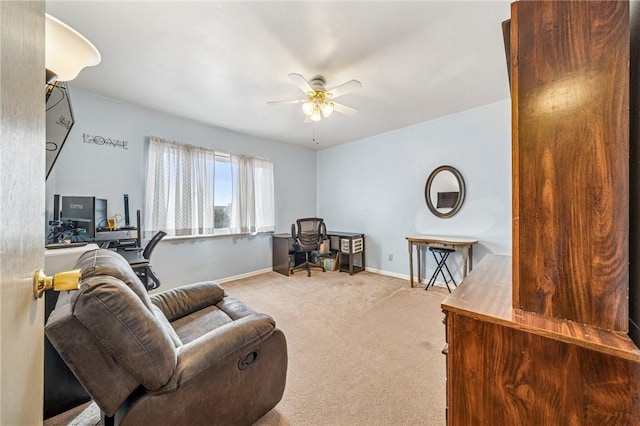 sitting room with baseboards, carpet, and a ceiling fan