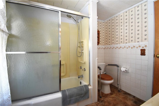 bathroom featuring toilet, tile walls, bath / shower combo with glass door, and crown molding