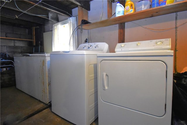 clothes washing area with washer and dryer and laundry area