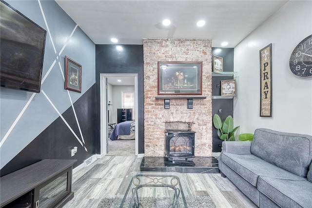 living area with recessed lighting, baseboards, and wood finished floors