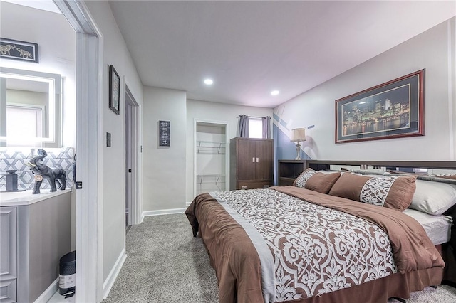 bedroom featuring recessed lighting, carpet, baseboards, and ensuite bathroom