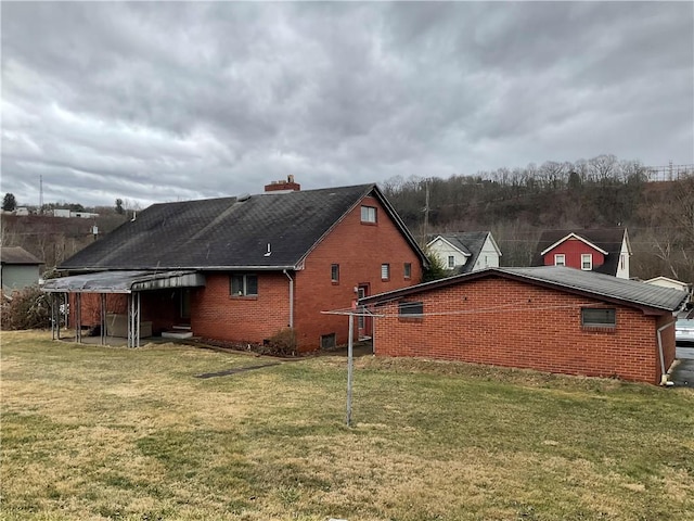 view of side of home with a lawn and brick siding