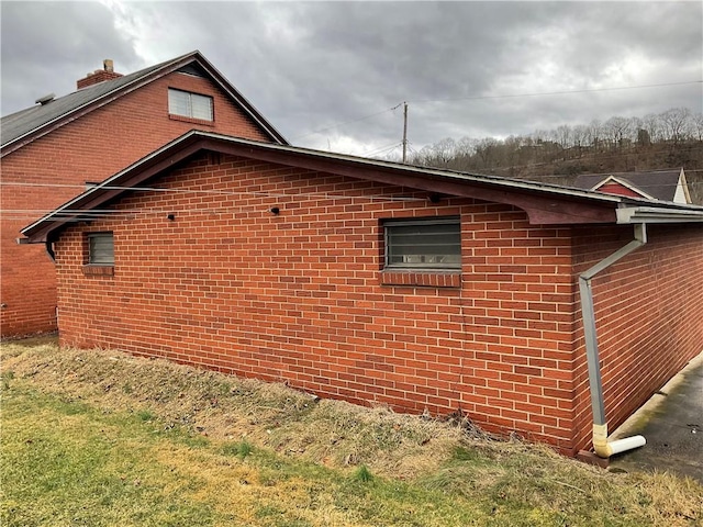 view of side of property featuring brick siding