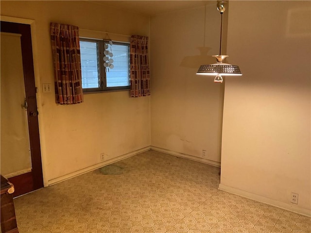 unfurnished room featuring tile patterned floors and baseboards