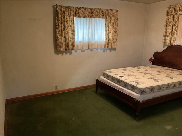 bedroom with baseboards and carpet floors