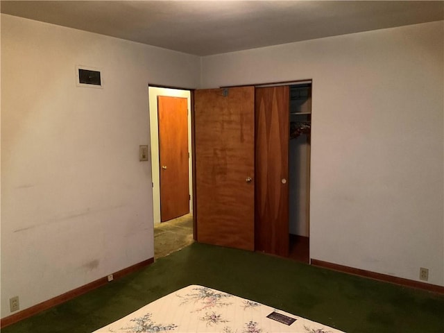 unfurnished bedroom featuring baseboards, visible vents, and a closet