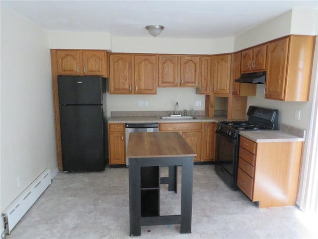 kitchen with brown cabinetry, a sink, black appliances, under cabinet range hood, and a baseboard heating unit