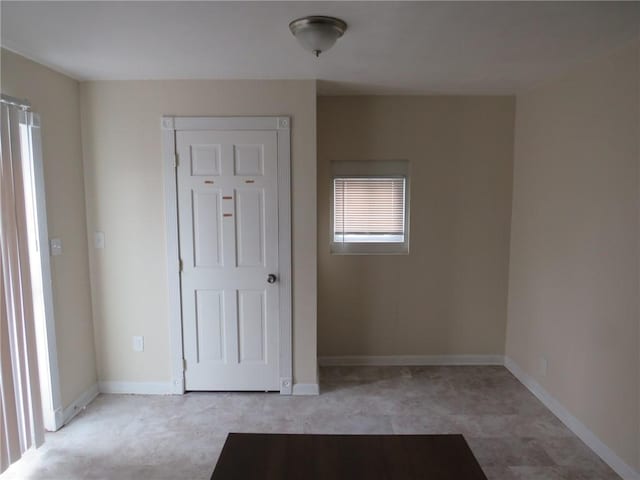 spare room with baseboards