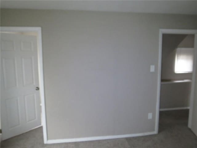 unfurnished room featuring baseboards