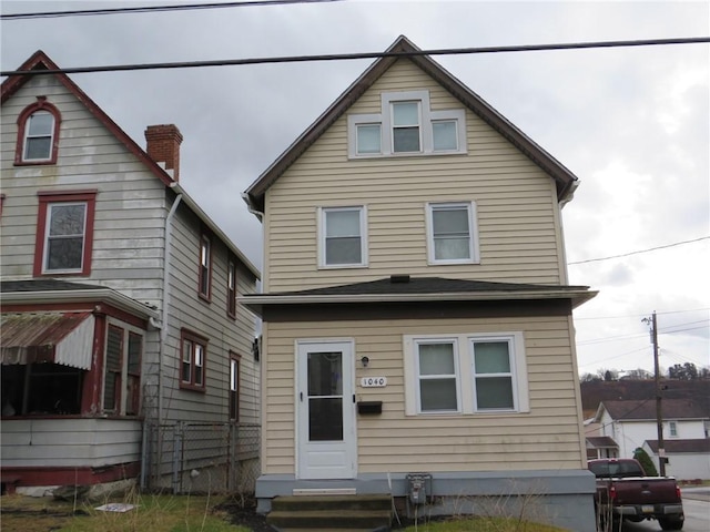 view of front facade with fence and entry steps