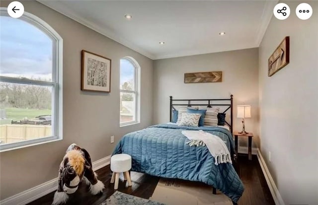 bedroom featuring recessed lighting, baseboards, wood finished floors, and crown molding