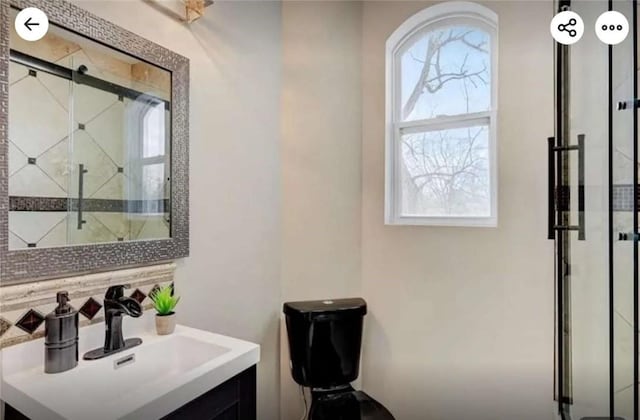 full bath featuring a stall shower and vanity