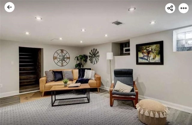 living room with recessed lighting and wood finished floors