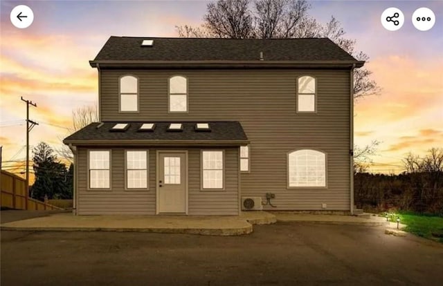 view of front of house featuring fence and a patio area