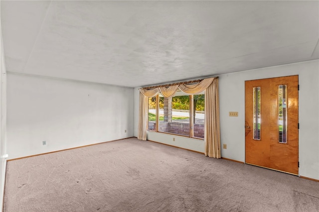 empty room with carpet flooring and baseboards