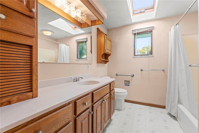 bathroom with tile patterned floors, toilet, a skylight, and a wealth of natural light