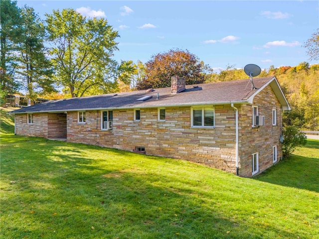 back of house with a yard, stone siding, and a chimney