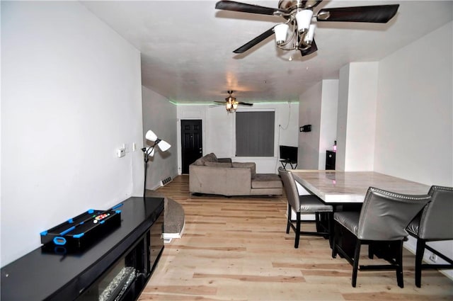 dining room featuring light wood-style floors and ceiling fan