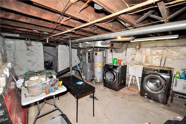 unfinished below grade area featuring heating unit, gas water heater, and washer and dryer