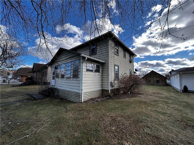 view of home's exterior with a yard