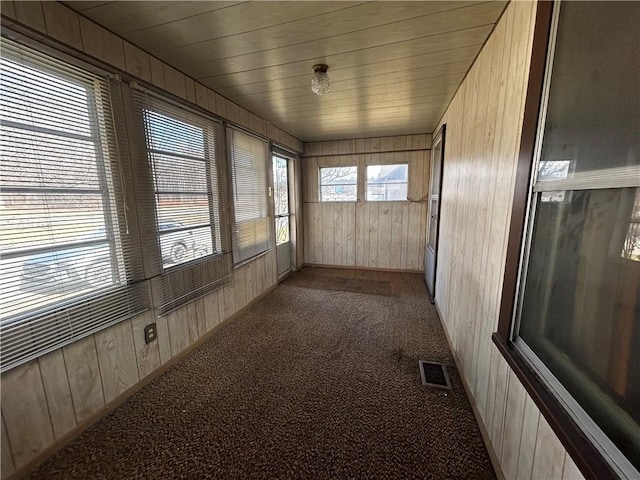 sunroom featuring visible vents and wood ceiling