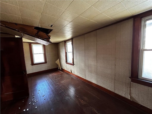 unfurnished room featuring hardwood / wood-style flooring and baseboards