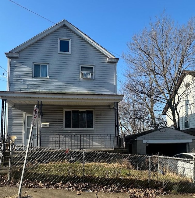 back of house with a fenced front yard, covered porch, and a detached garage