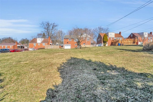 view of yard featuring a residential view and fence