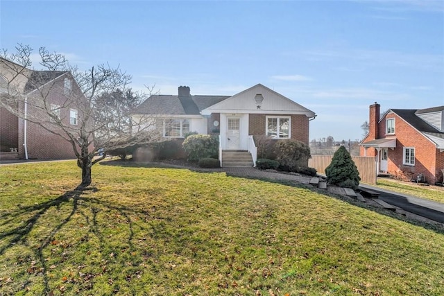 bungalow-style house with a front lawn and brick siding