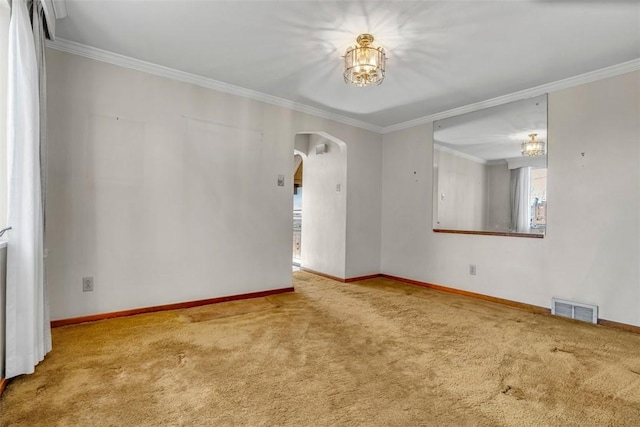 carpeted empty room featuring baseboards, visible vents, arched walkways, ornamental molding, and a wealth of natural light