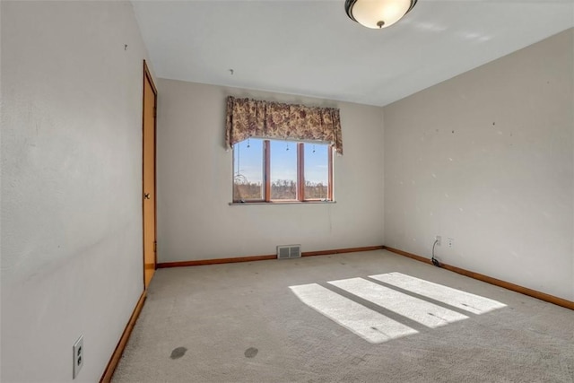 empty room with visible vents, baseboards, and carpet floors